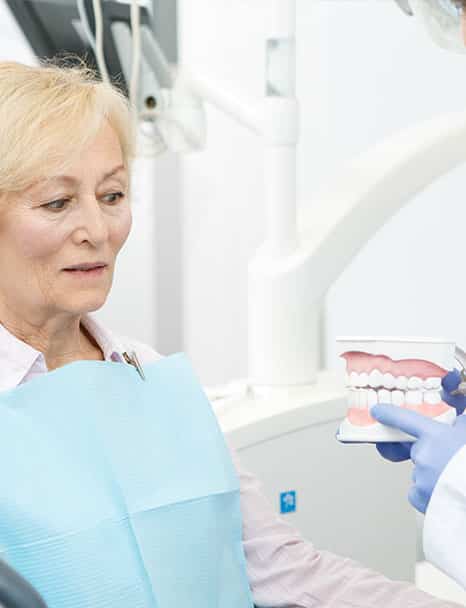 Doctor Giving Demo to Elderly Patient — Pain Free Dental Clinic In Moss Vale, NSW