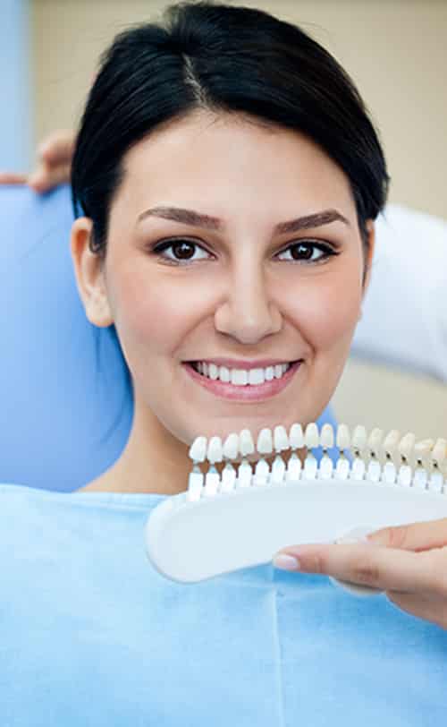Smiling Woman With Palette For Tooth Color — Pain Free Dental Clinic In Moss Vale, NSW