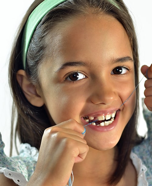 Little Girl Flossing Her Teeth — Pain Free Dental Clinic In Moss Vale, NSW