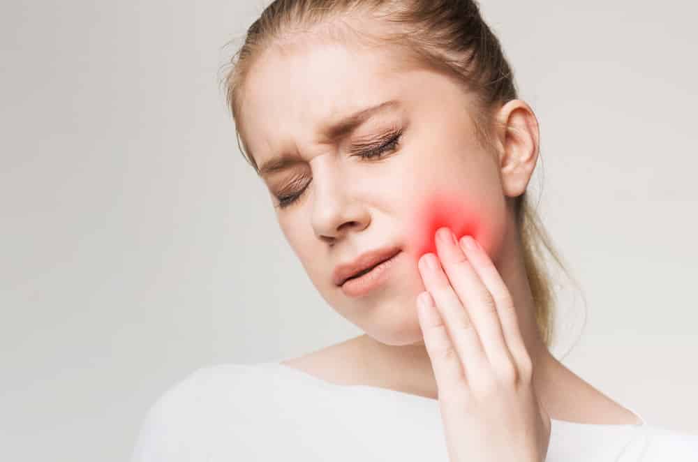 Young Woman Suffering From Abscessed Tooth