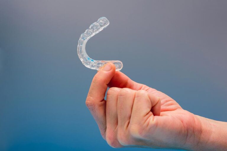 Man Holding Clear Aligners